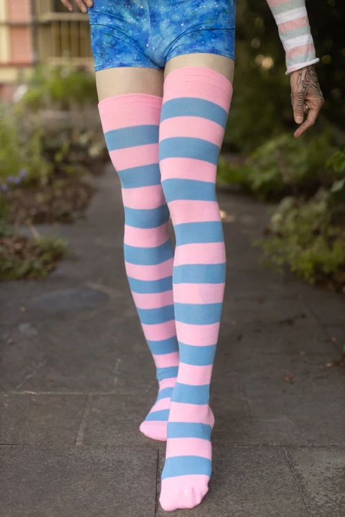 Photograph of blue and pink striped thigh highs worn by a person