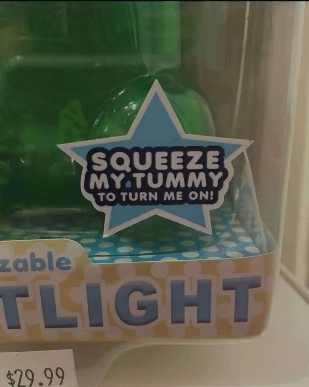 plastic toy packaging with text reading "squeeze my tummy to turn me on"